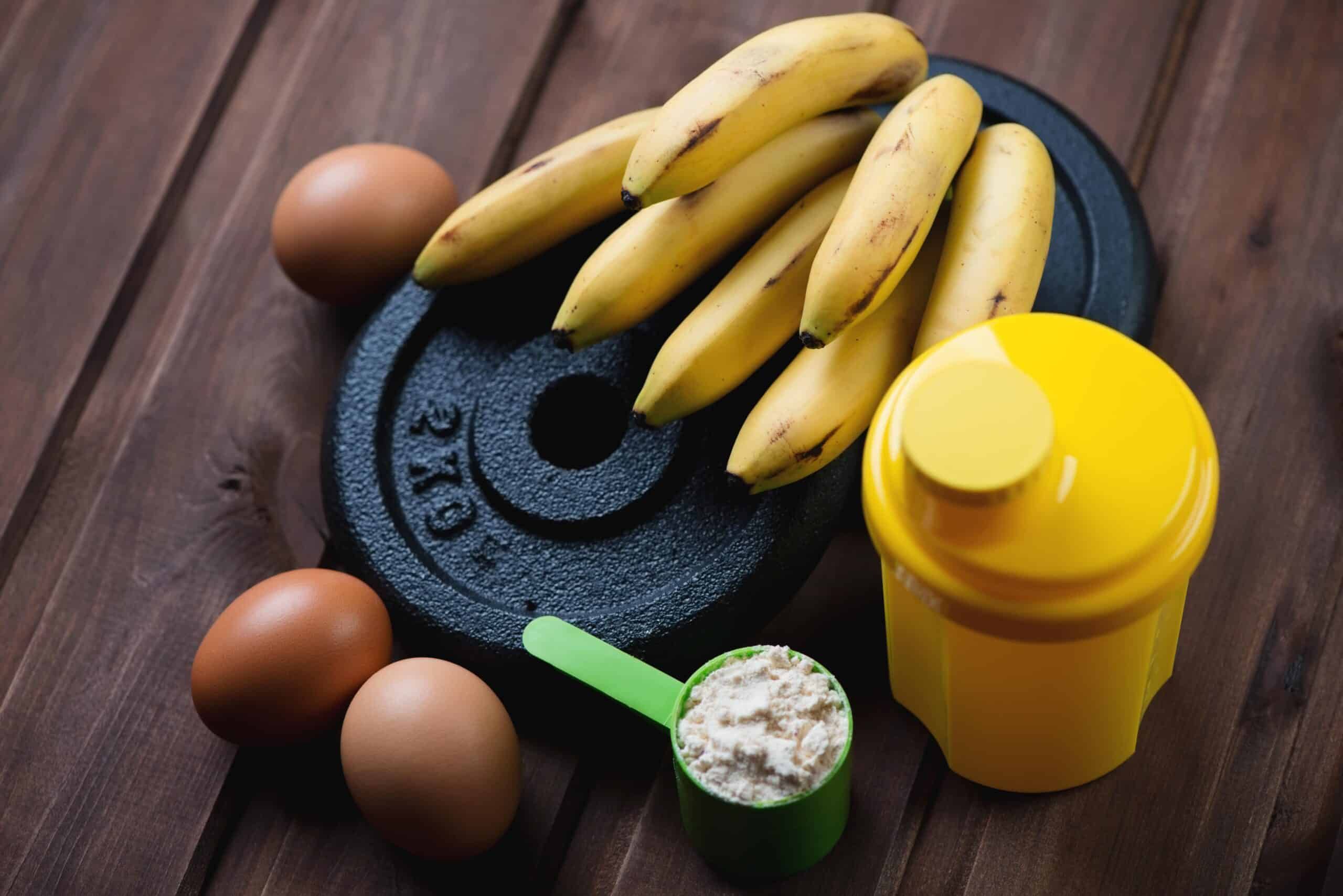 bananas, eggs, protein shake, and exercise equipment