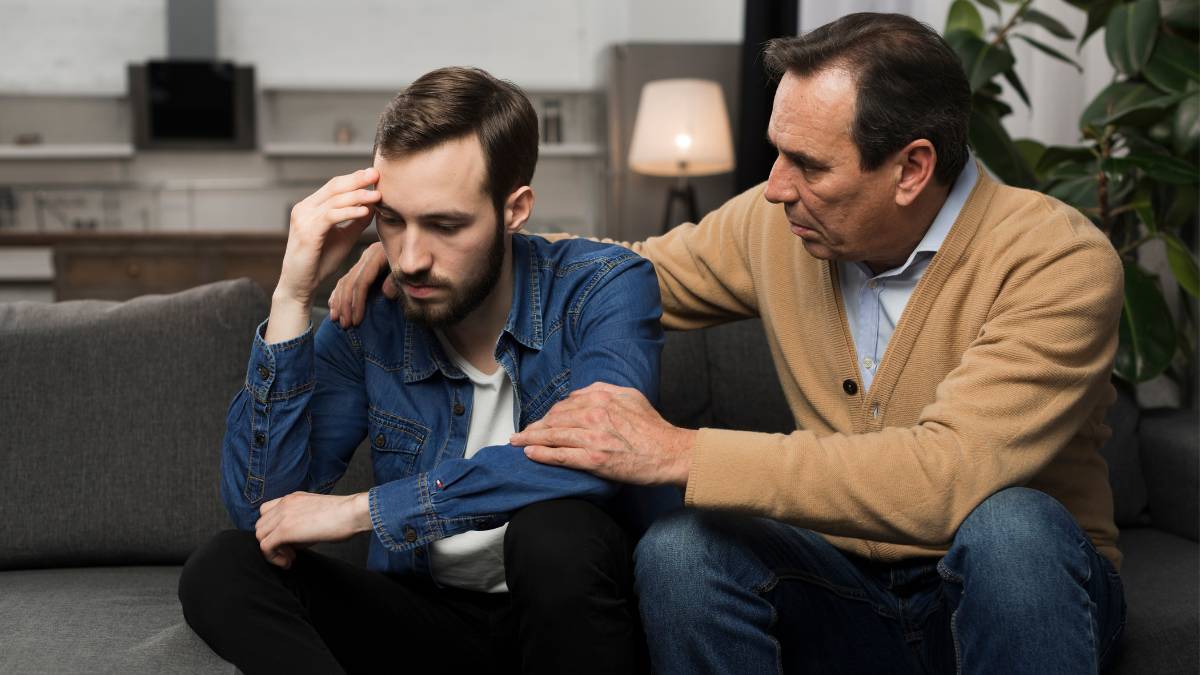A man encouraging his son to go to rehab through conversation.