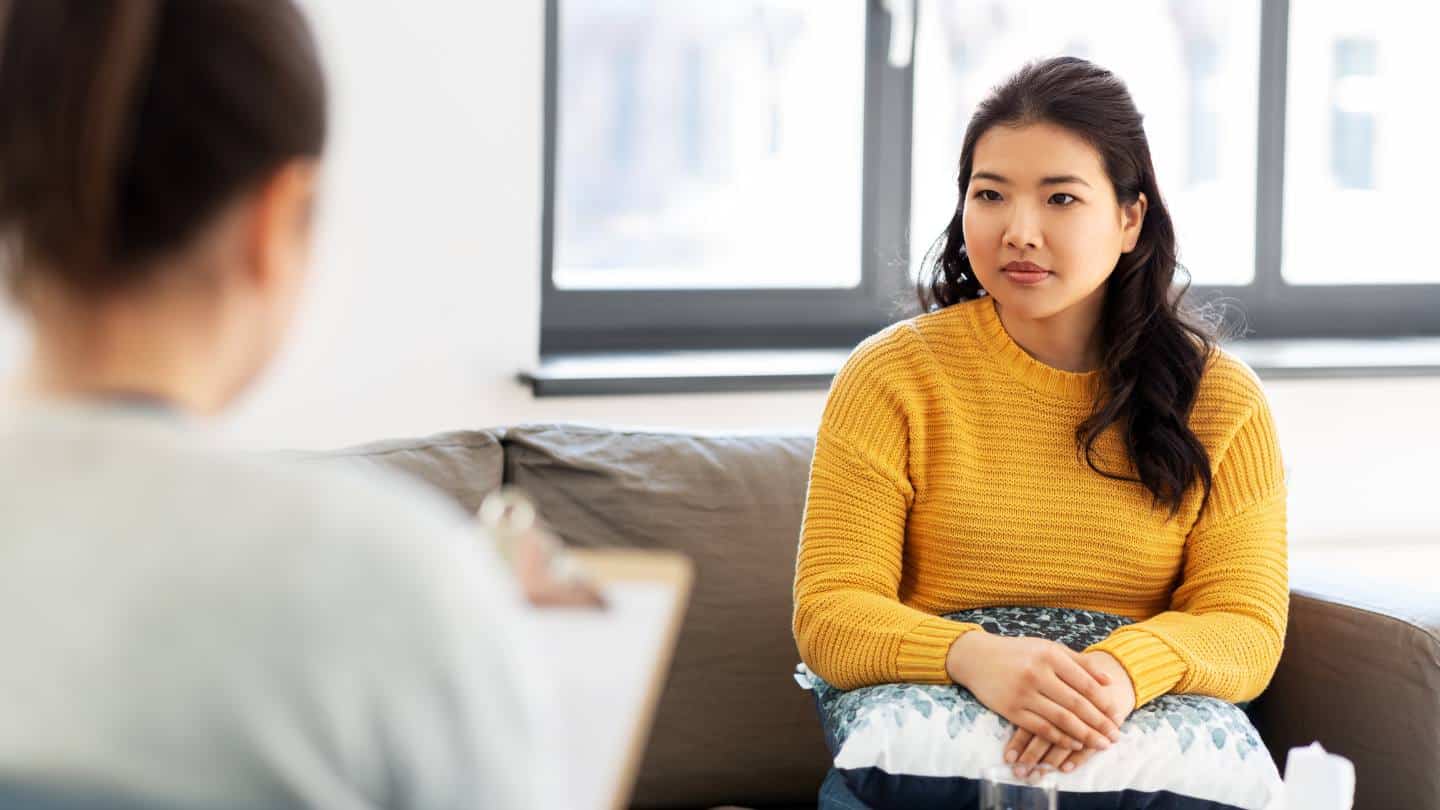 A woman seated in a calm therapy room receiving bipolar disorder treatment in New Jersey.