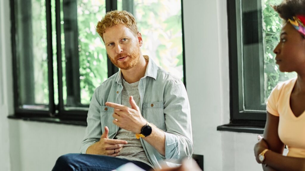 A man shares his struggle with SUD during a group therapy exercise.