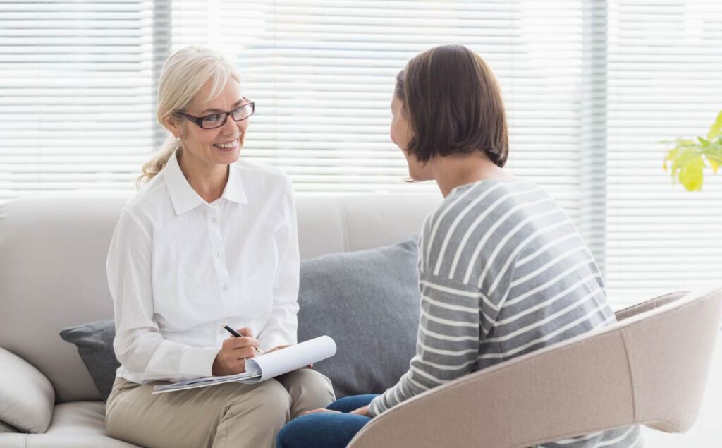 Woman receiving guidance from a professional on Linden drug and alcohol rehab resources.