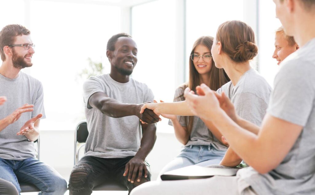 Man greeting peers in a session as part of Linden drug and alcohol rehab resources.