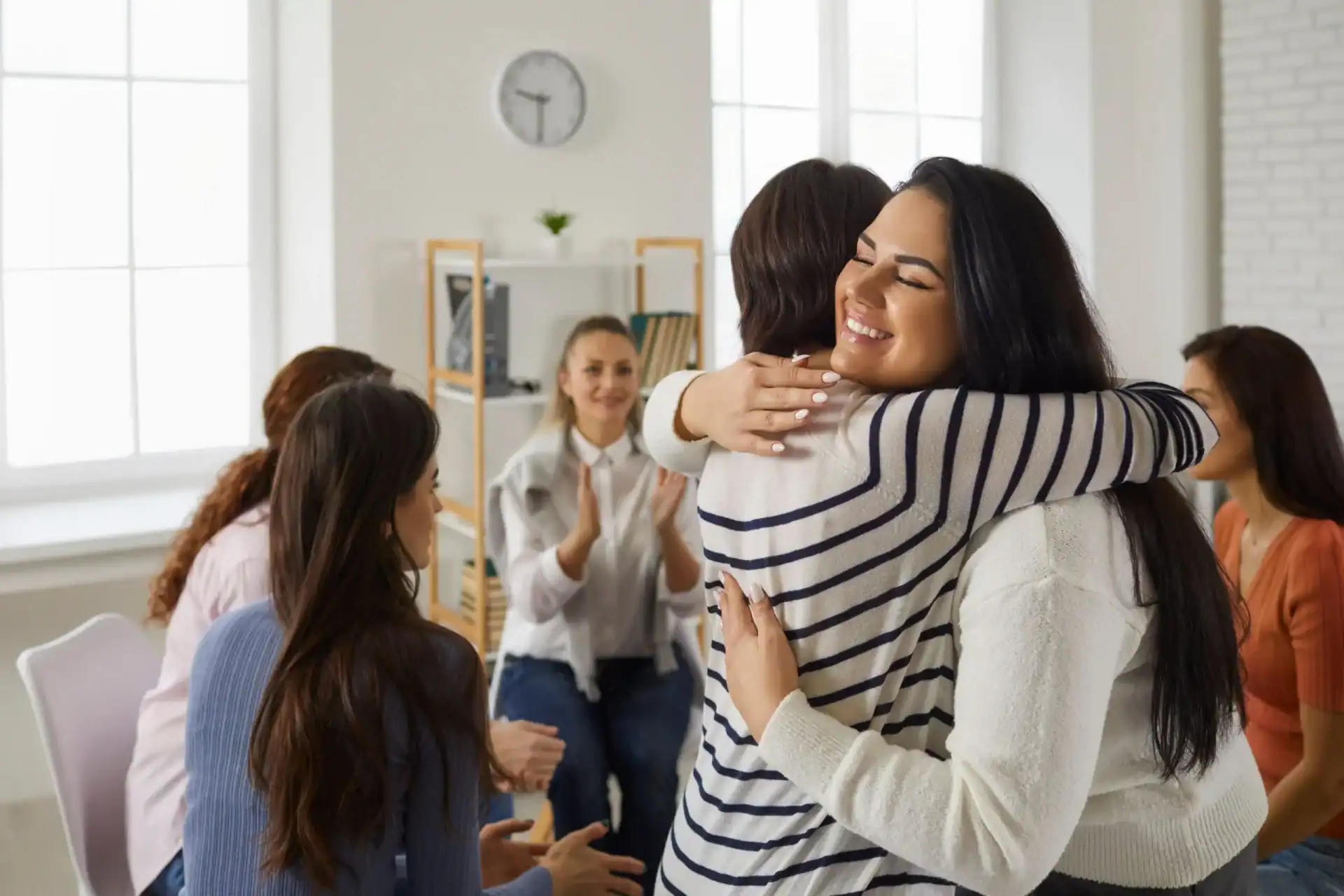 Women embrace during a group therapy session at our Kalamazoo residential rehab.