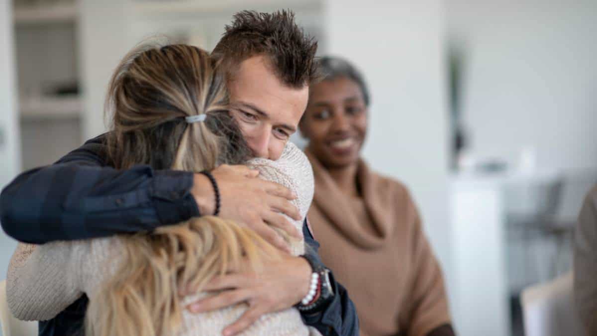 Man hugging a loved one during therapy session at a heroin addiction treatment in New Jersey.