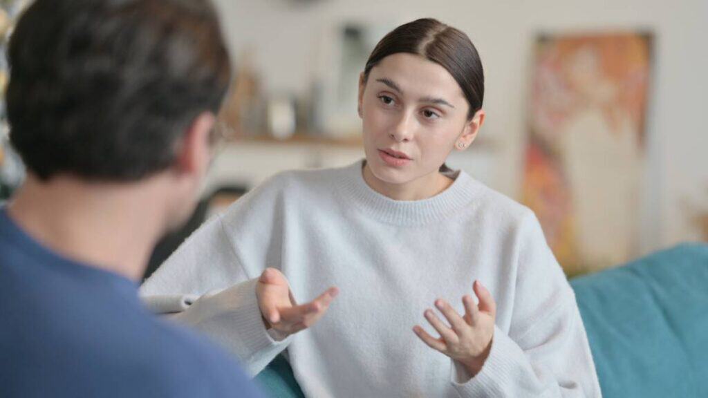 A professional engages in one-on-one discussion with a client as part of personalized addiction treatment.