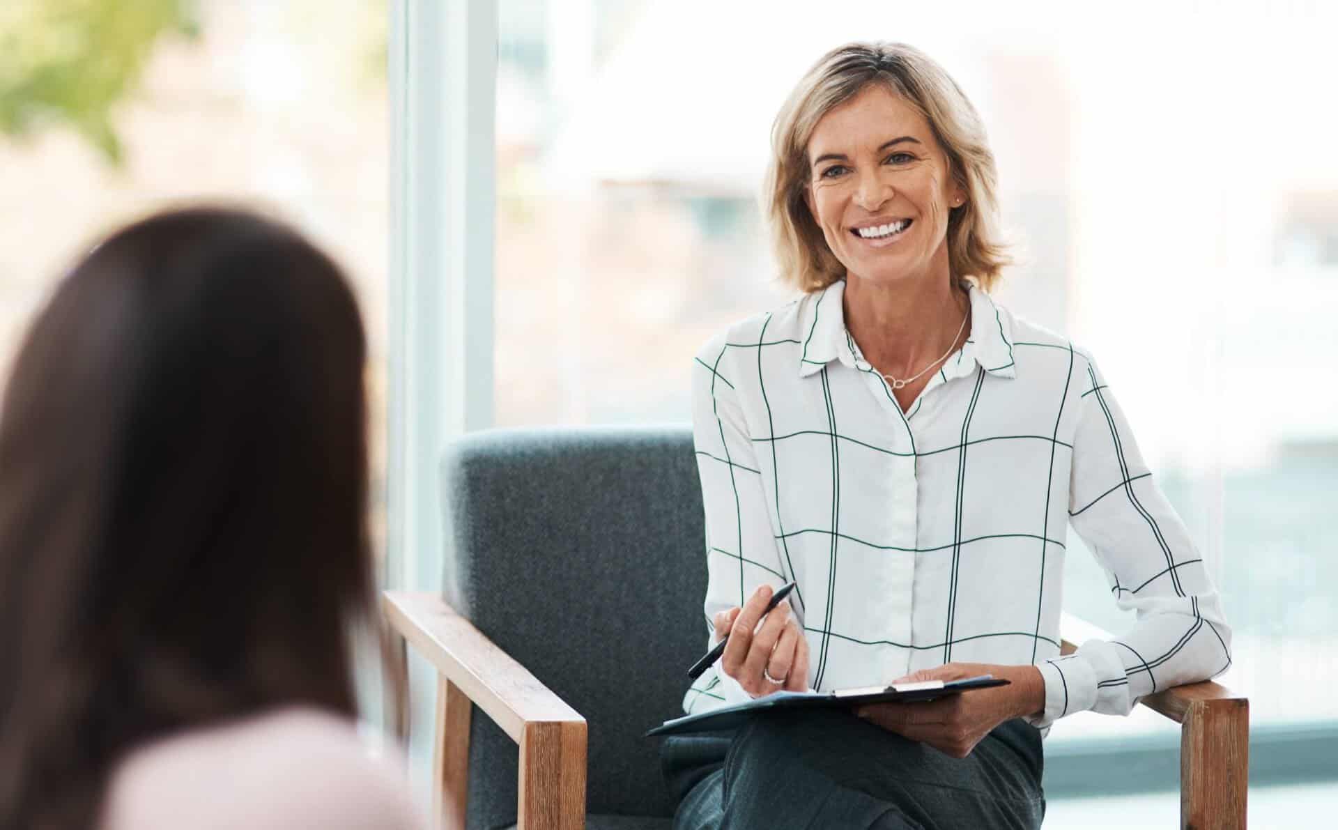 Therapist talking with a client during their first therapy session.
