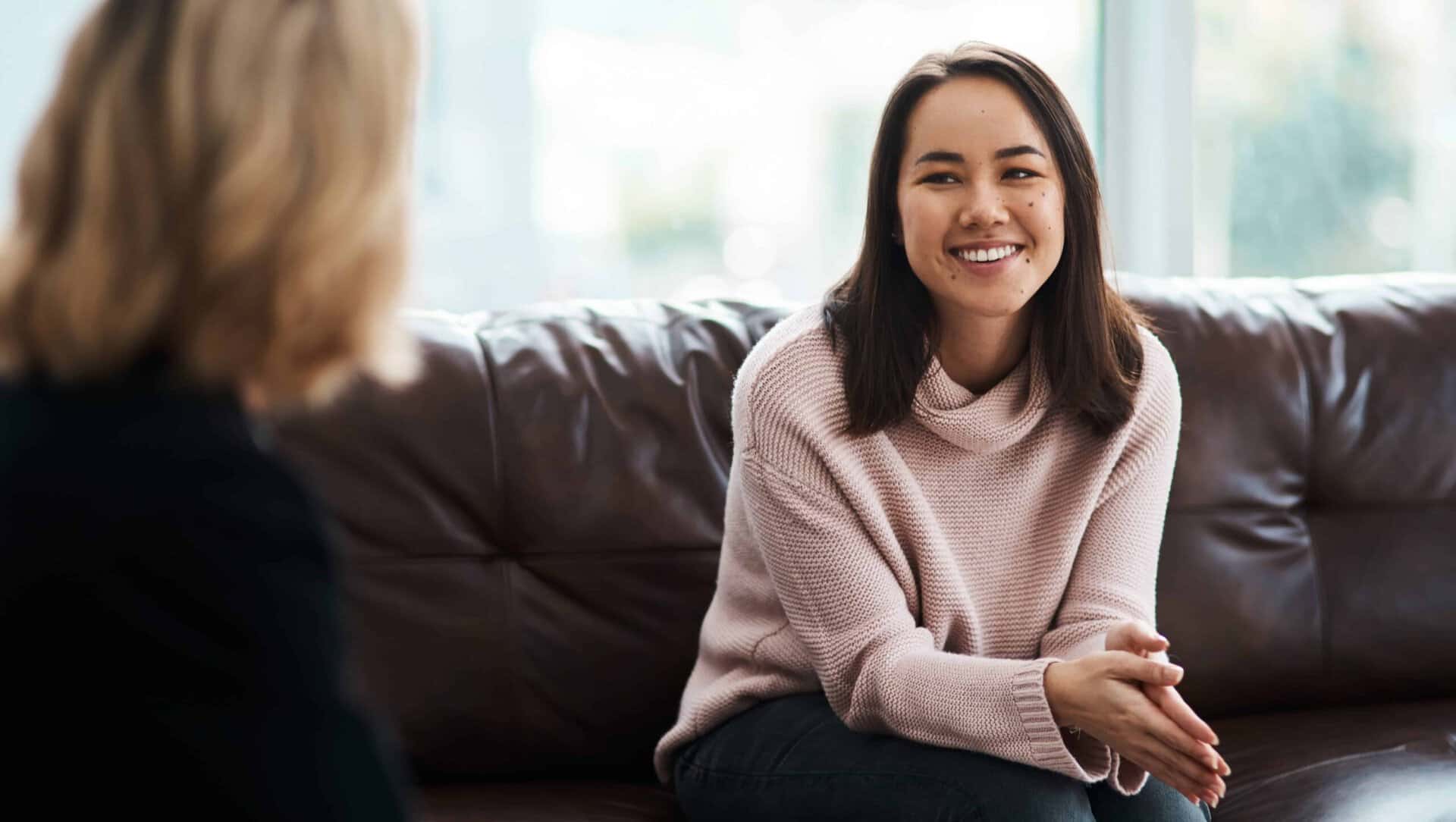 A sober woman discussing the signs your liver is healing with a professional.